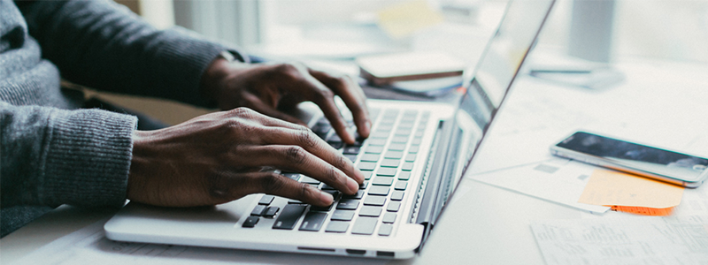 Man typing on a laptop